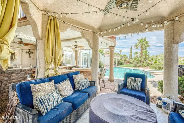 a living room with fireplace furniture and a large window