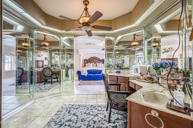 a living room with couches a fireplace and a dining table with a large window