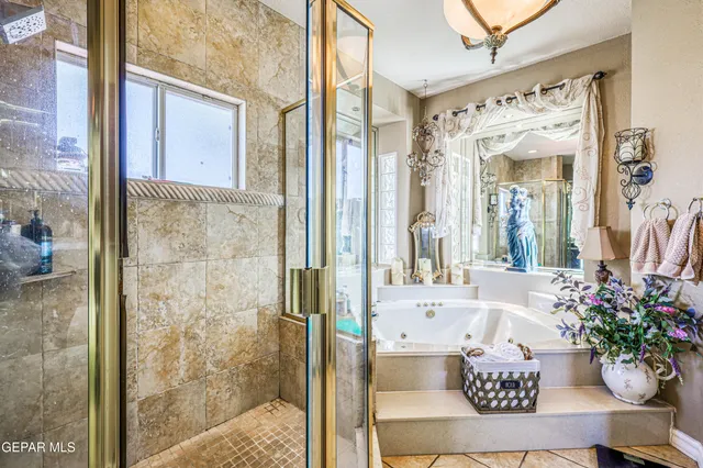 a bathroom with a tub shower and mirror