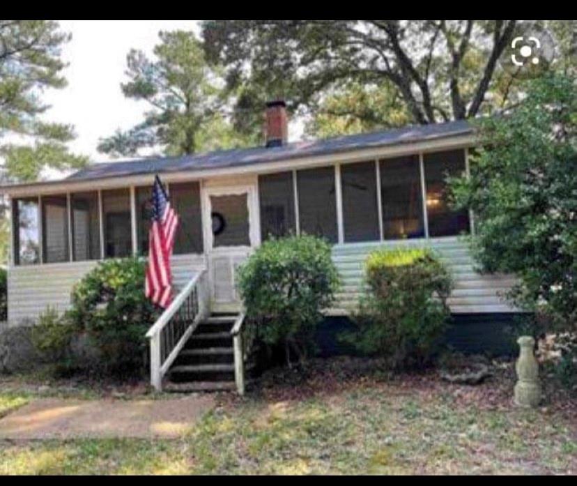 12095 Flat Shoals Road Covington, GA 30016 - Photo 1 of 1 a front view of a house with garden