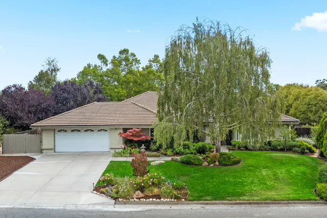 a front view of a house with garden