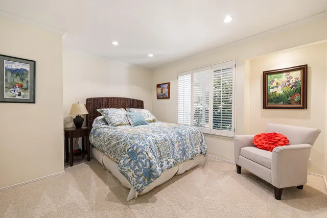 a bedroom with a bed and a couch