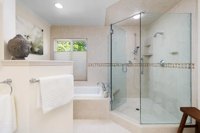 a bathroom with a bathtub and a shower