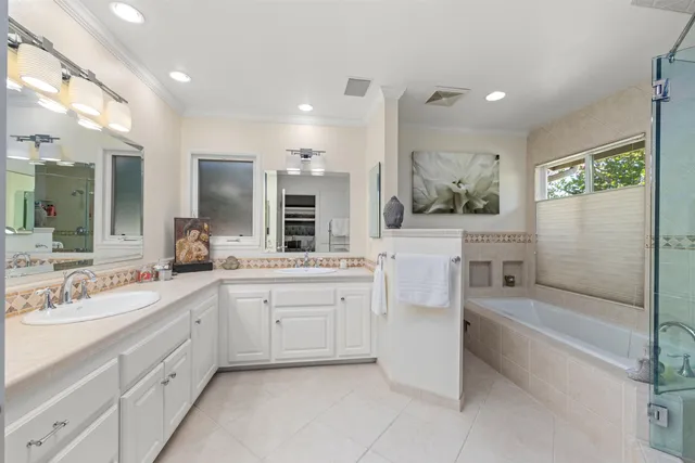 a bathroom with a granite countertop sink mirror and bathtub