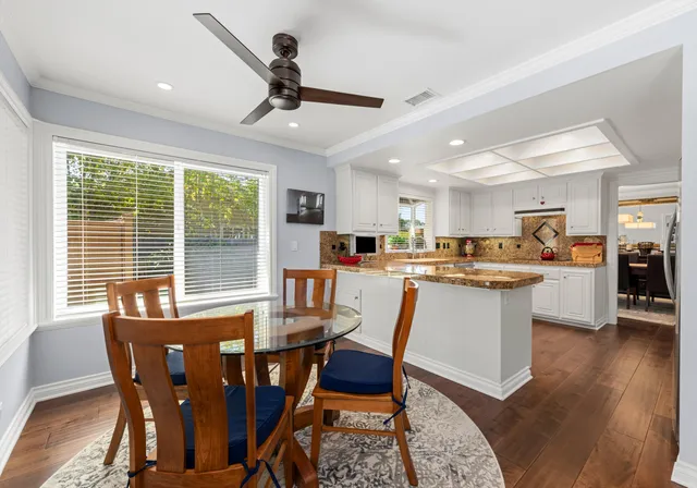 a view of a dining room with furniture window and wooden floor