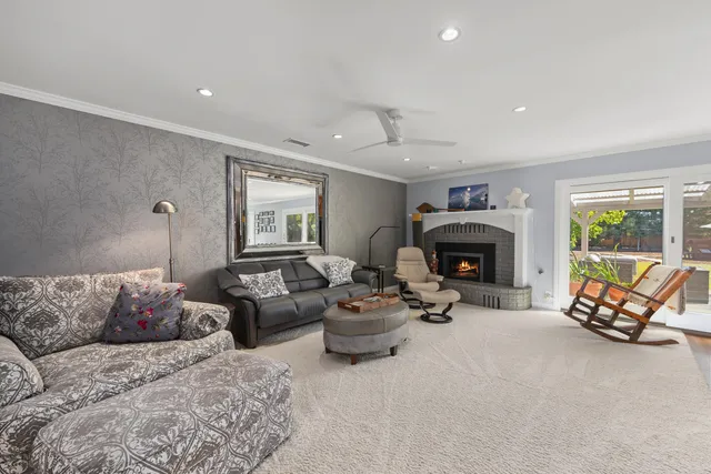 a living room with furniture fireplace and a fireplace