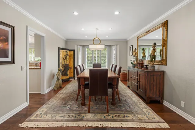 a view of a a dining room with furniture window and wooden floor