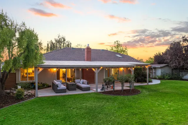 a view of house with backyard and patio