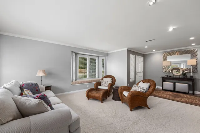 a living room with furniture and a lamp