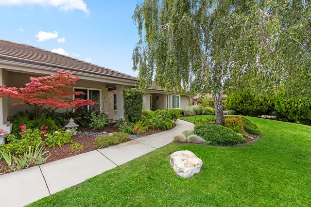 a view of a house with a backyard and garden