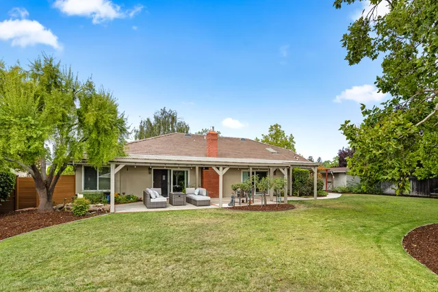 a front view of a house with swimming pool having outdoor seating