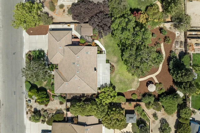 an aerial view of a house with a yard and garden
