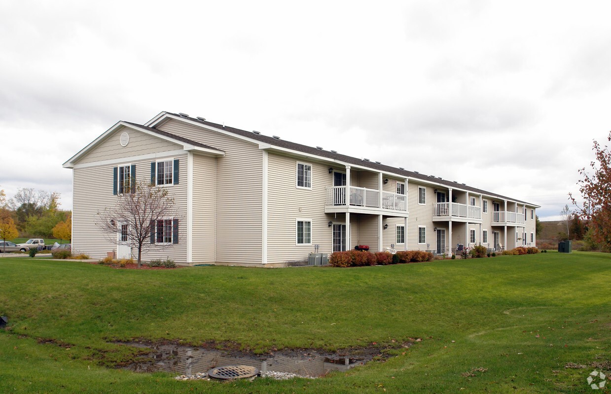 417 Maynard Street Charlotte, MI 48813 - Photo 2 of 7 a front view of a house with a garden and lake view