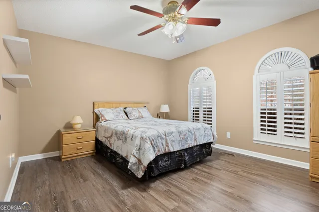 a spacious bedroom with a bed and a chandelier