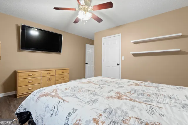 a bedroom with a bed and a flat screen tv