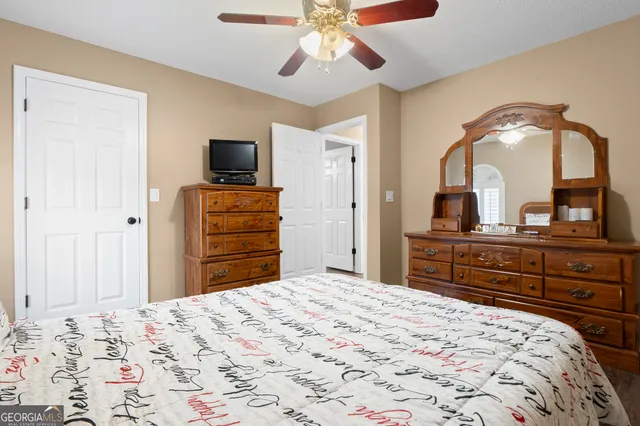 a bedroom with a bed and a television