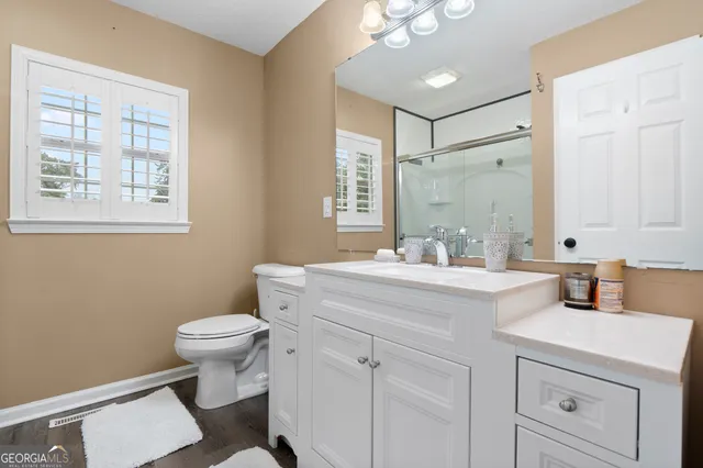 a bathroom with a sink toilet a mirror and a vanity