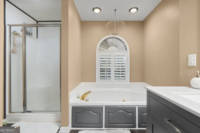 a bathroom with a bathtub and a window