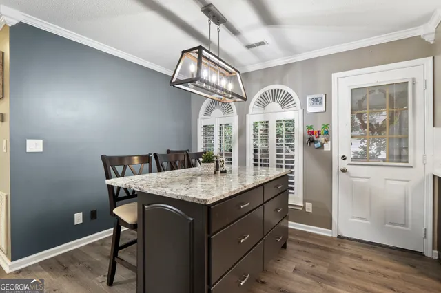 a view of a room that has a table and chairs