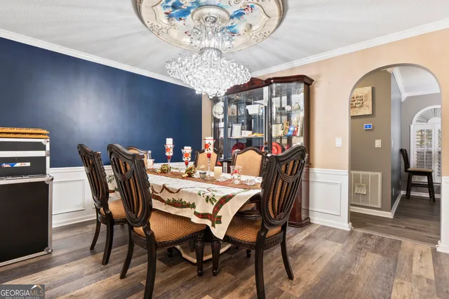 a view of a dining room with furniture wooden floor and chandelier