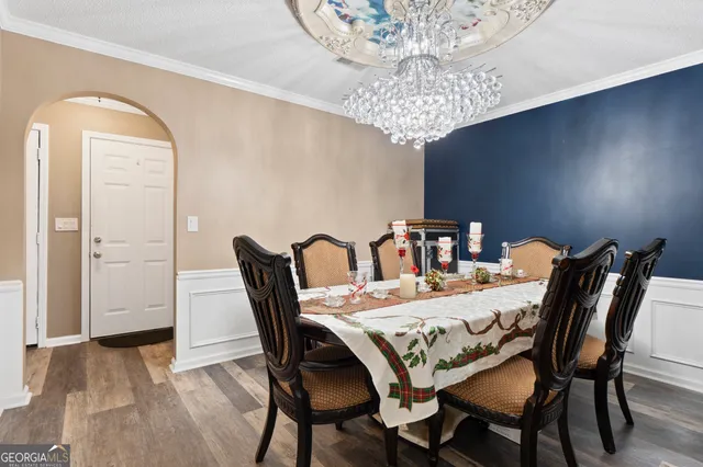 a view of a dining room with furniture and chandelier