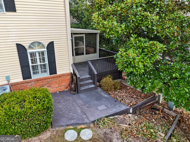 a view of backyard with seating space and trees