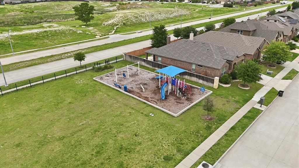 11500 Starlight Ranch Fort Worth, TX 76052 - Photo 37 of 40 Aerial view of the surrounding neighbourhood with residential properties and a public playground featuring swings, slides, and a shaded structure