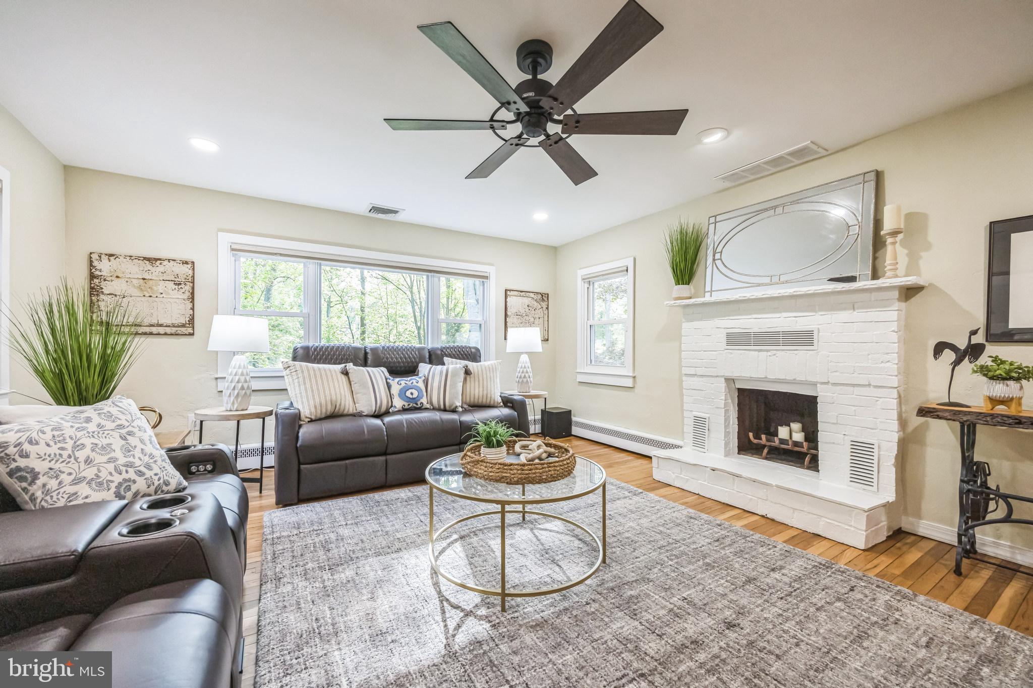 700 Pine Ridge Road Media, PA 19063 - Photo 16 of 50 a living room with furniture a fireplace and a large window