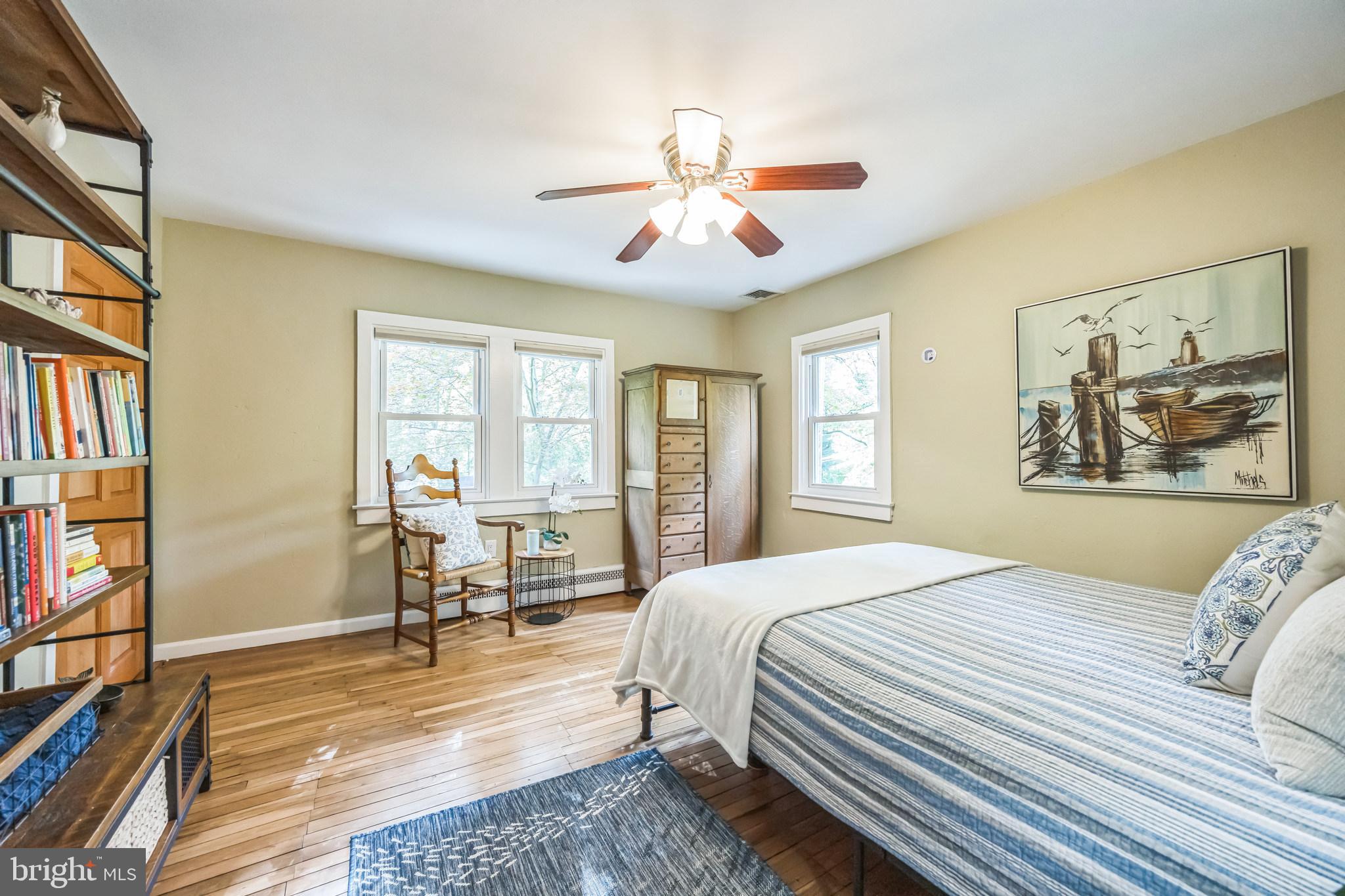 700 Pine Ridge Road Media, PA 19063 - Photo 20 of 50 a bedroom with a large bed a chandelier and a book shelf