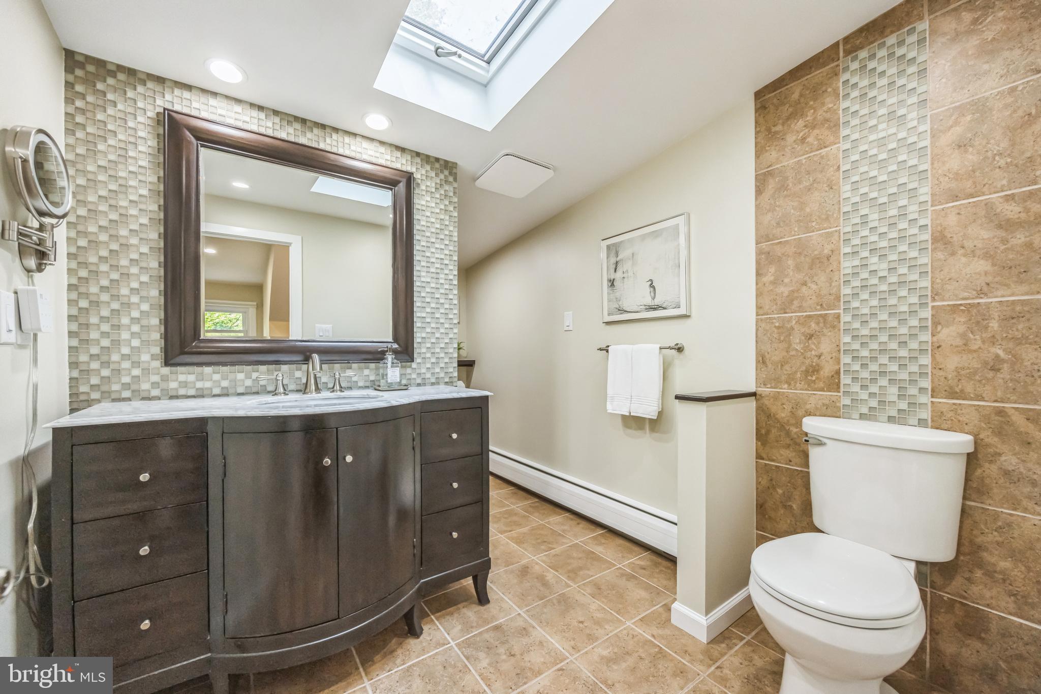 700 Pine Ridge Road Media, PA 19063 - Photo 31 of 50 a bathroom with a granite countertop toilet sink and mirror