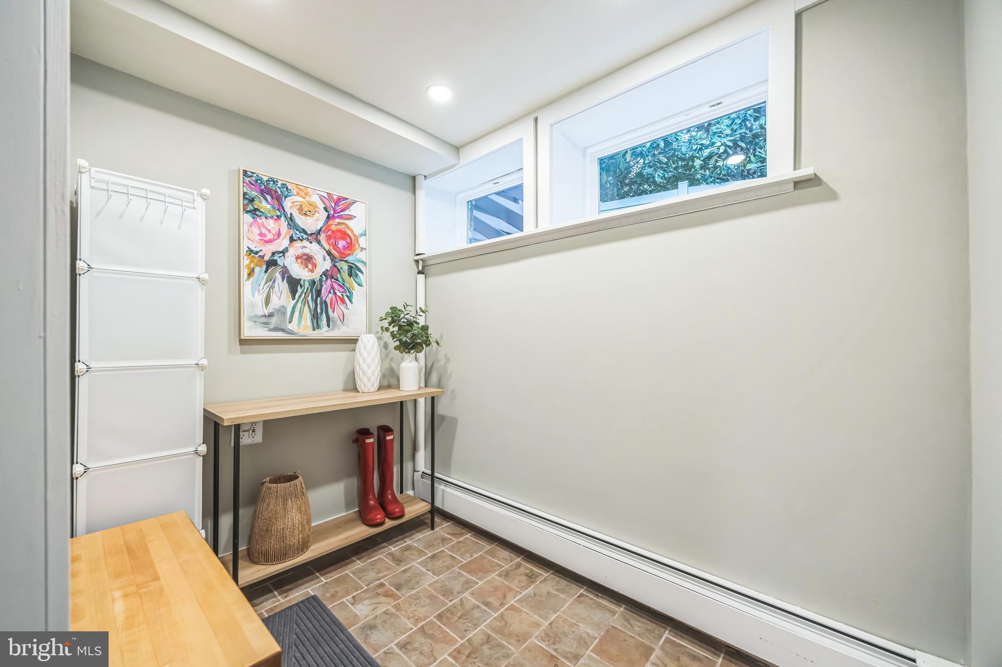 700 Pine Ridge Road Media, PA 19063 - Photo 43 of 50 a room with a painting on the wall and a potted plant