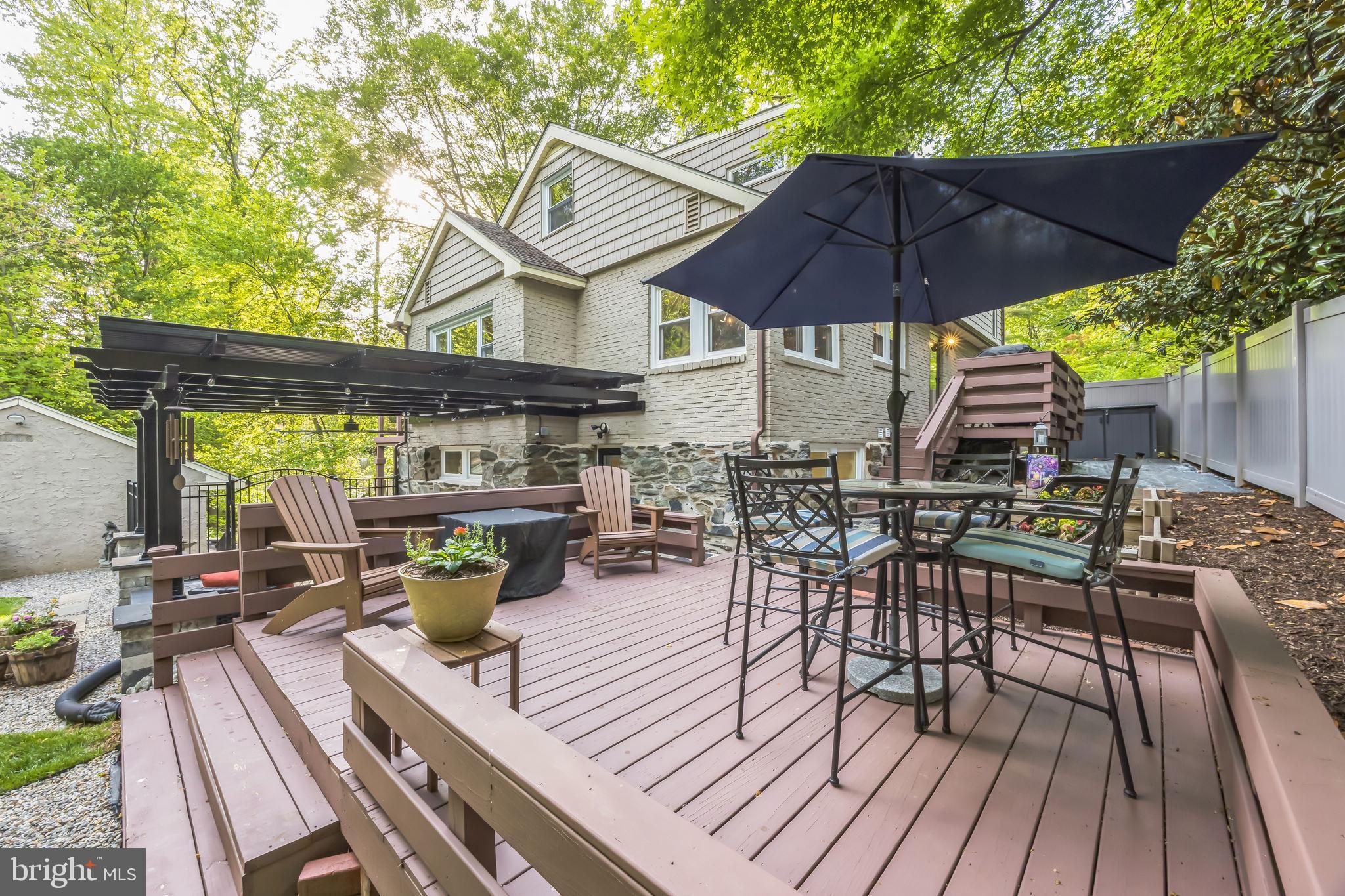 700 Pine Ridge Road Media, PA 19063 - Photo 45 of 50 a view of deck with table and chairs under an umbrella with wooden floor