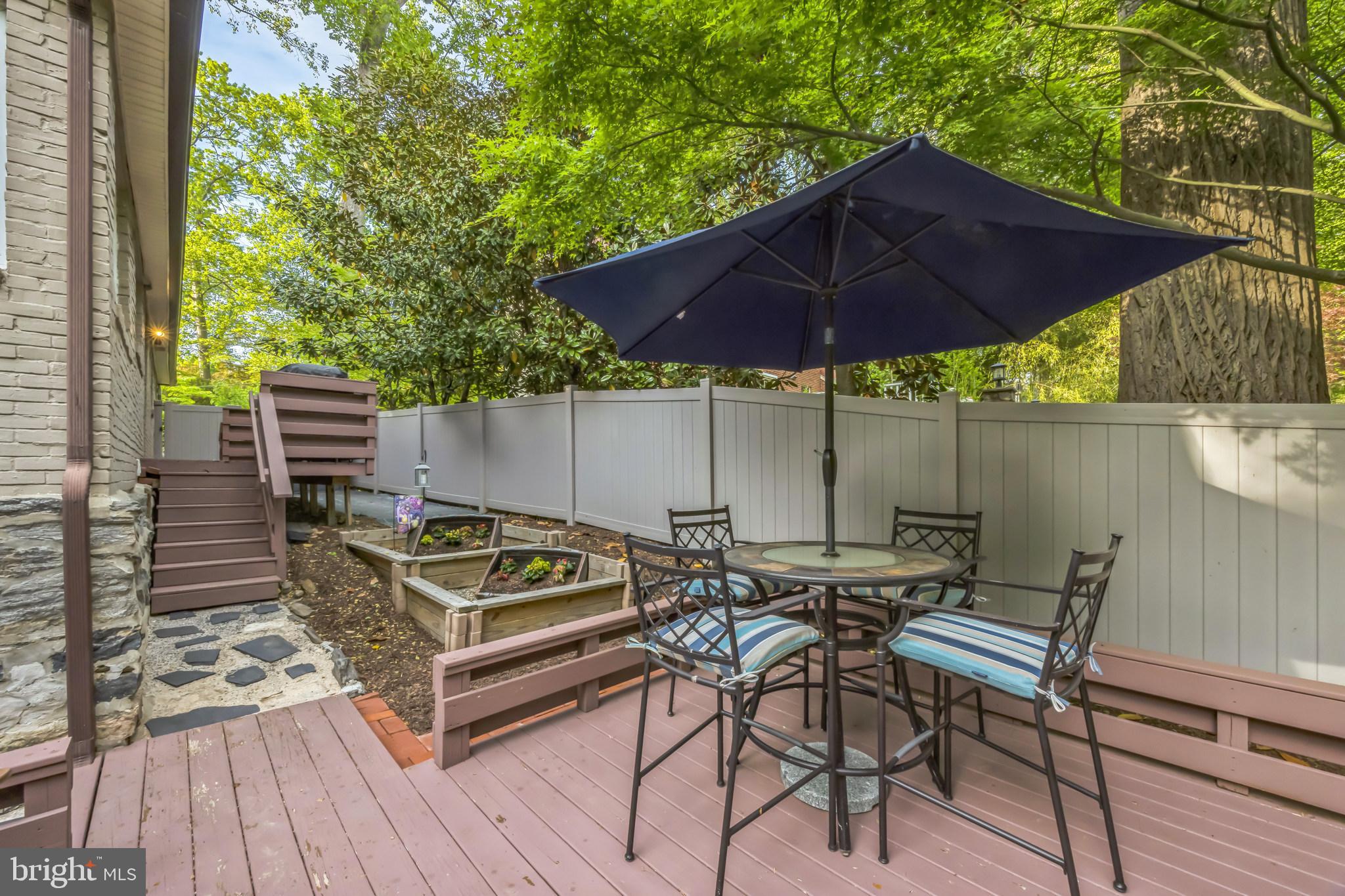 700 Pine Ridge Road Media, PA 19063 - Photo 46 of 50 a view of wooden table and chairs under an umbrella