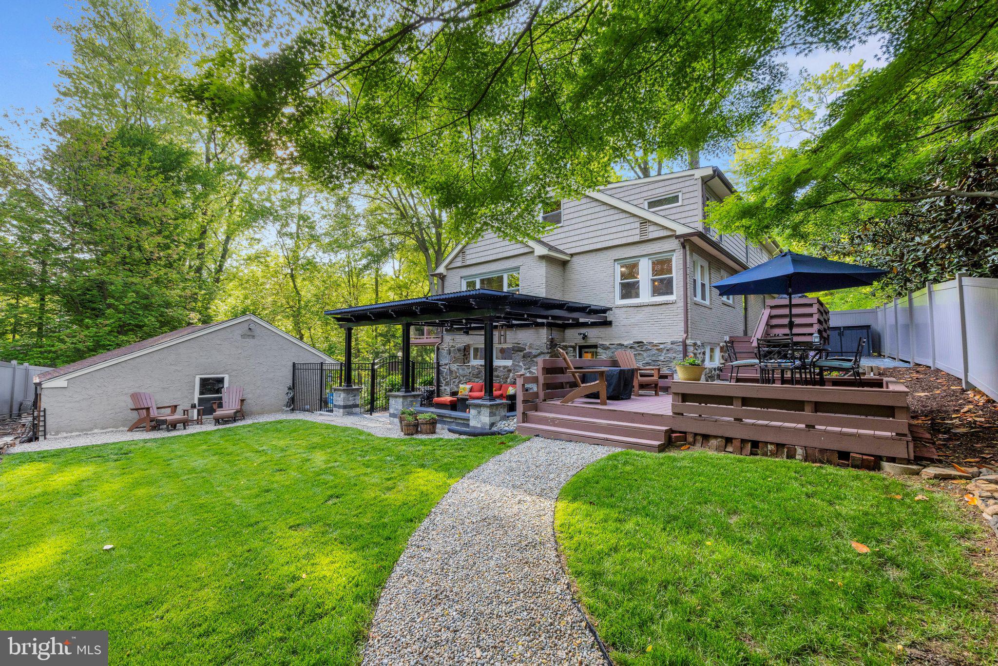 700 Pine Ridge Road Media, PA 19063 - Photo 49 of 50 a front view of a house with a garden and sitting area