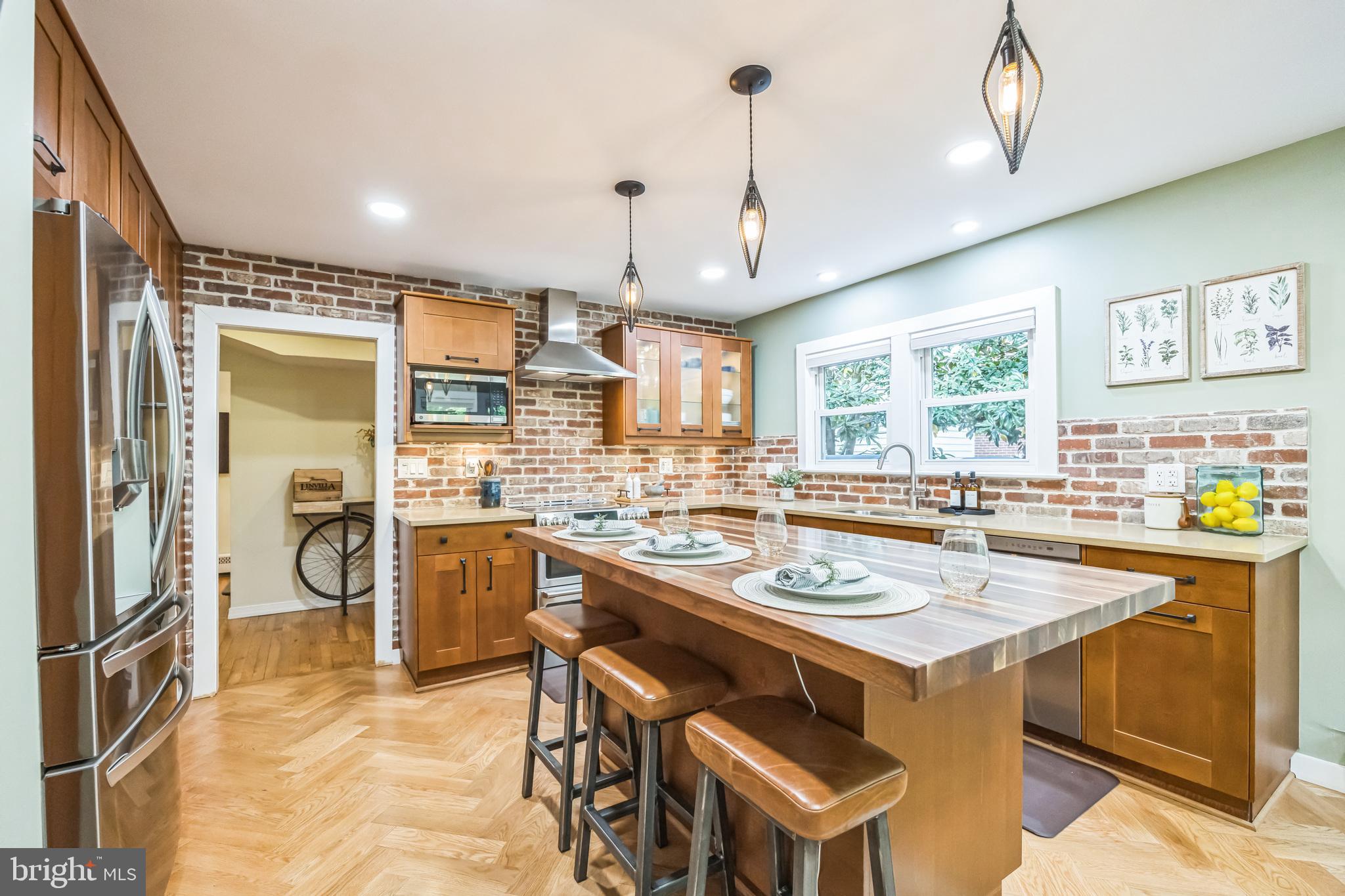 700 Pine Ridge Road Media, PA 19063 - Photo 6 of 50 a kitchen with a stove a refrigerator a sink and a dining table with wooden floor