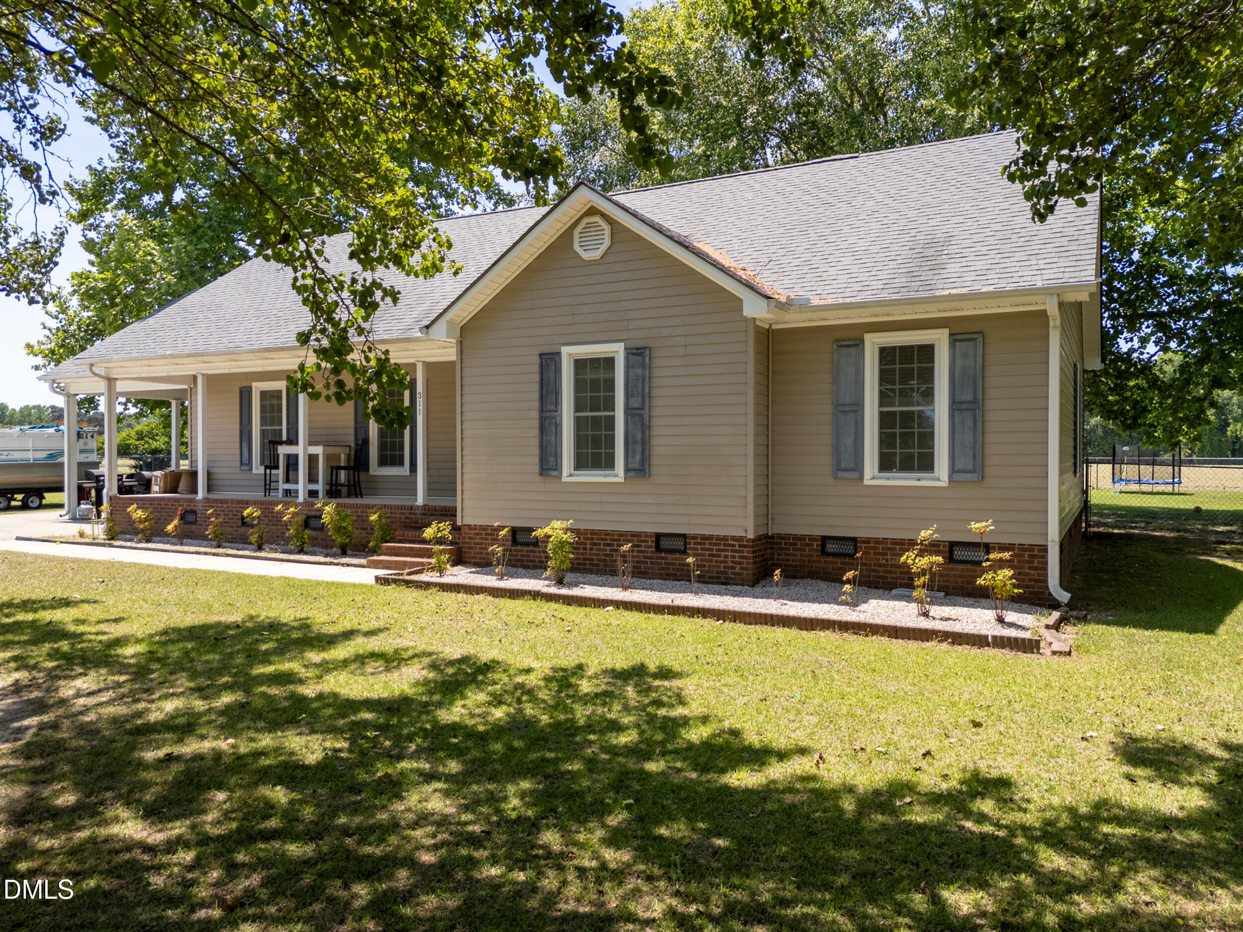 311 Bridgers Road Kenly, NC 27542 - Photo 4 of 46 a view of house with swimming pool and outdoor seating