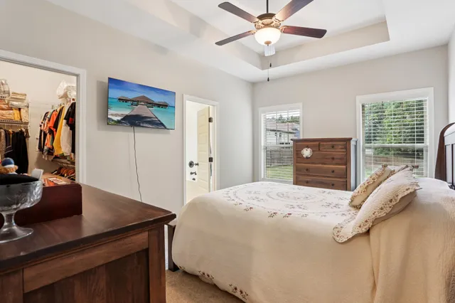 a large bedroom with a bed and a dresser in it