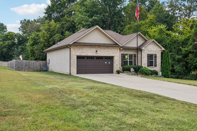 a view of a house with a yard and garage