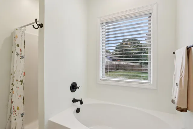 a view of walk in closet with clothes