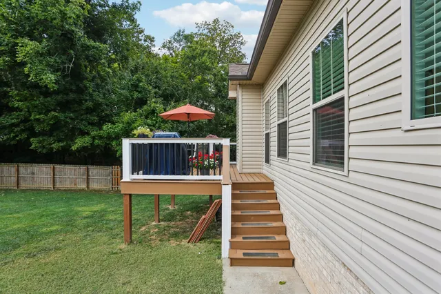 a view of a house with a yard and sitting area