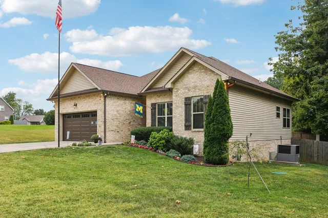 a front view of house with yard and green space