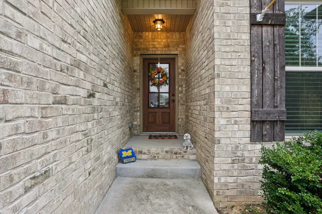 view of a brick house with many windows