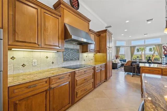 a dining room with furniture and a floor to ceiling window