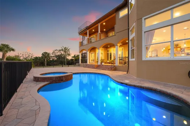 a living room with furniture a fireplace and large windows