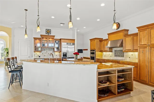 a kitchen with stainless steel appliances a stove and more cabinets