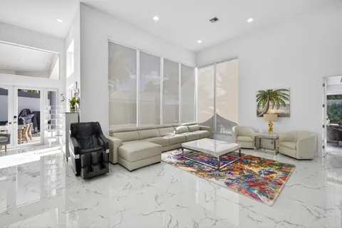 a living room with furniture and large windows