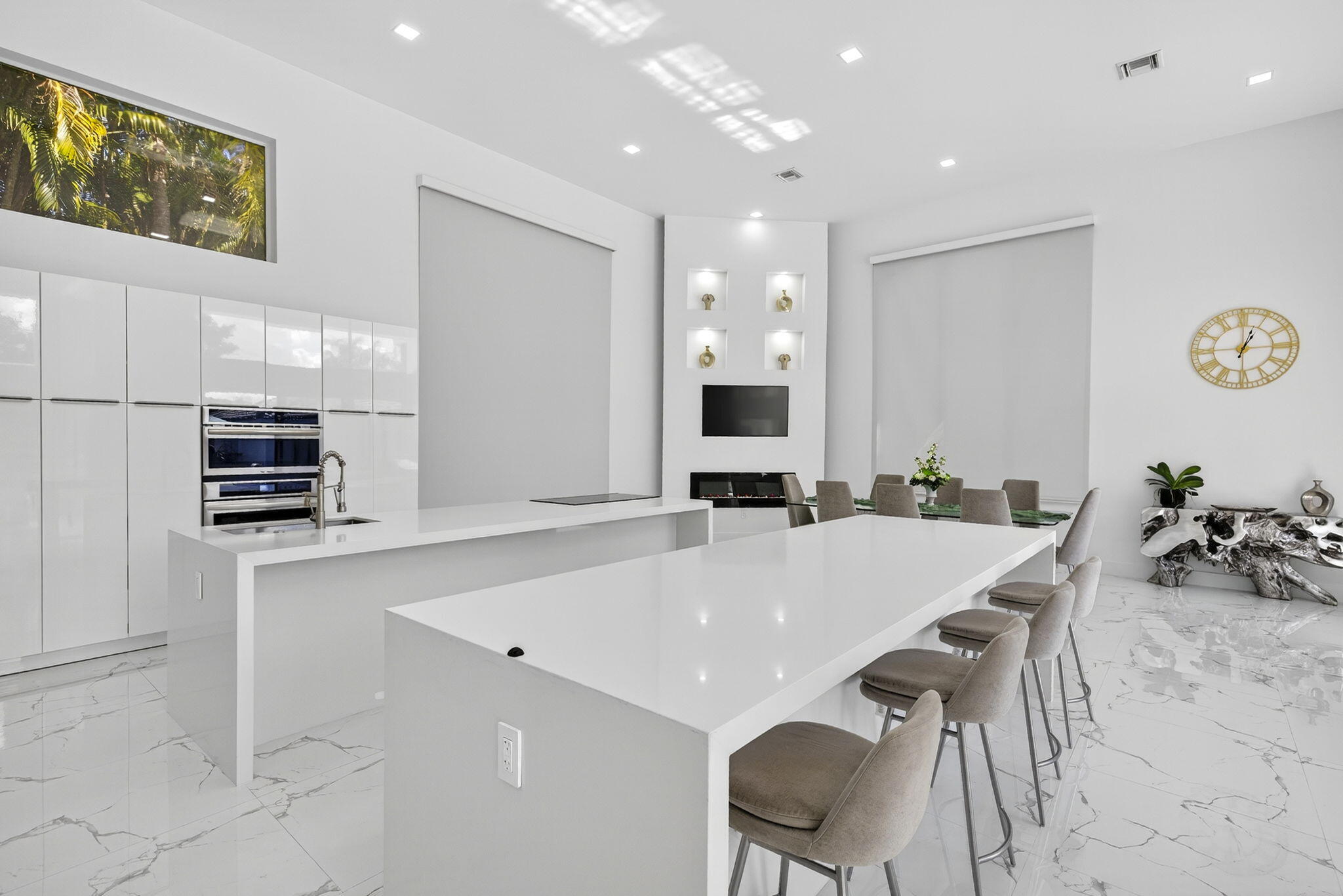 2673 Northwest 64th Boulevard Boca Raton, FL 33496 - Photo 17 of 64 a kitchen with stainless steel appliances a table and chairs in it