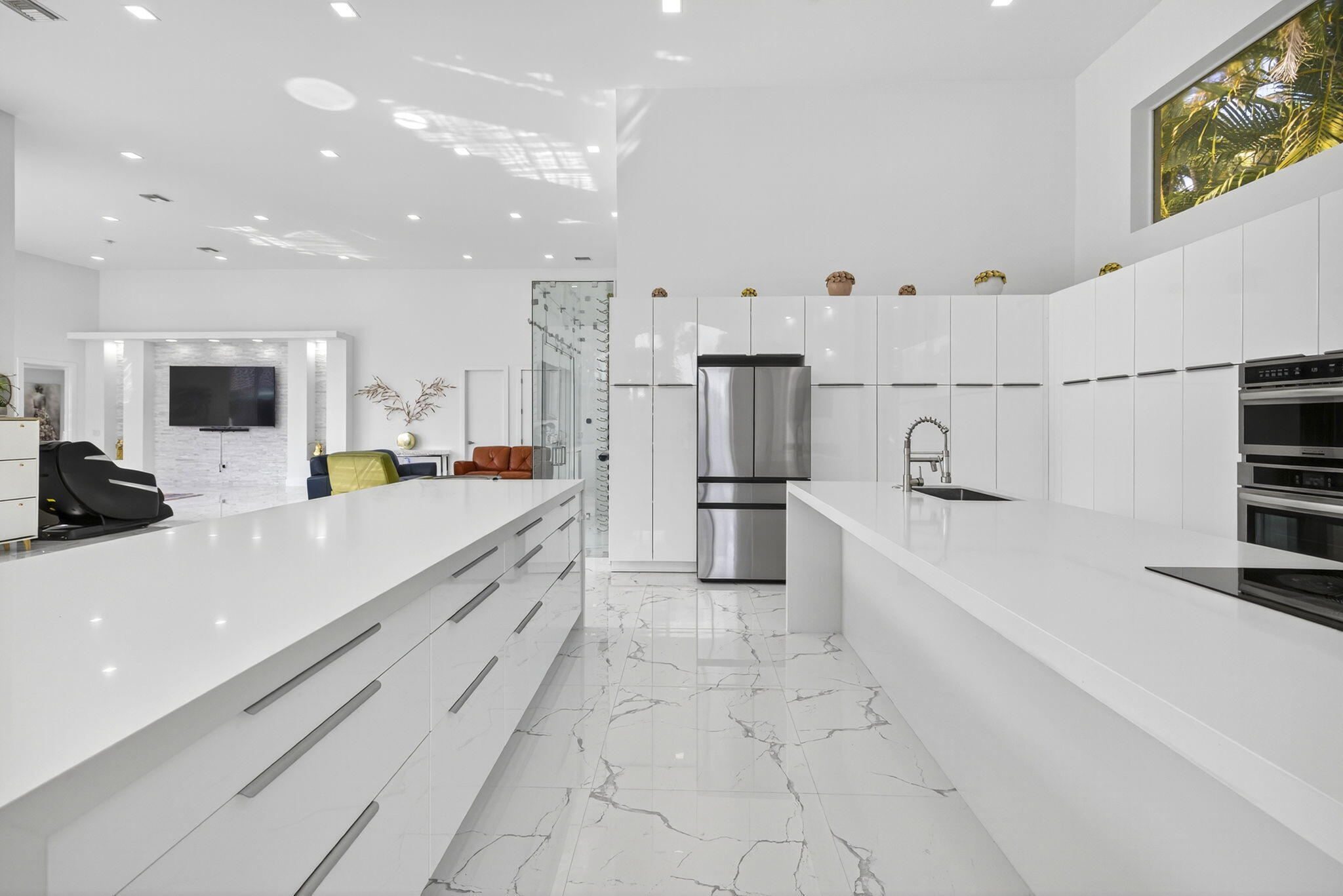 2673 Northwest 64th Boulevard Boca Raton, FL 33496 - Photo 20 of 64 a large white kitchen with stainless steel appliances