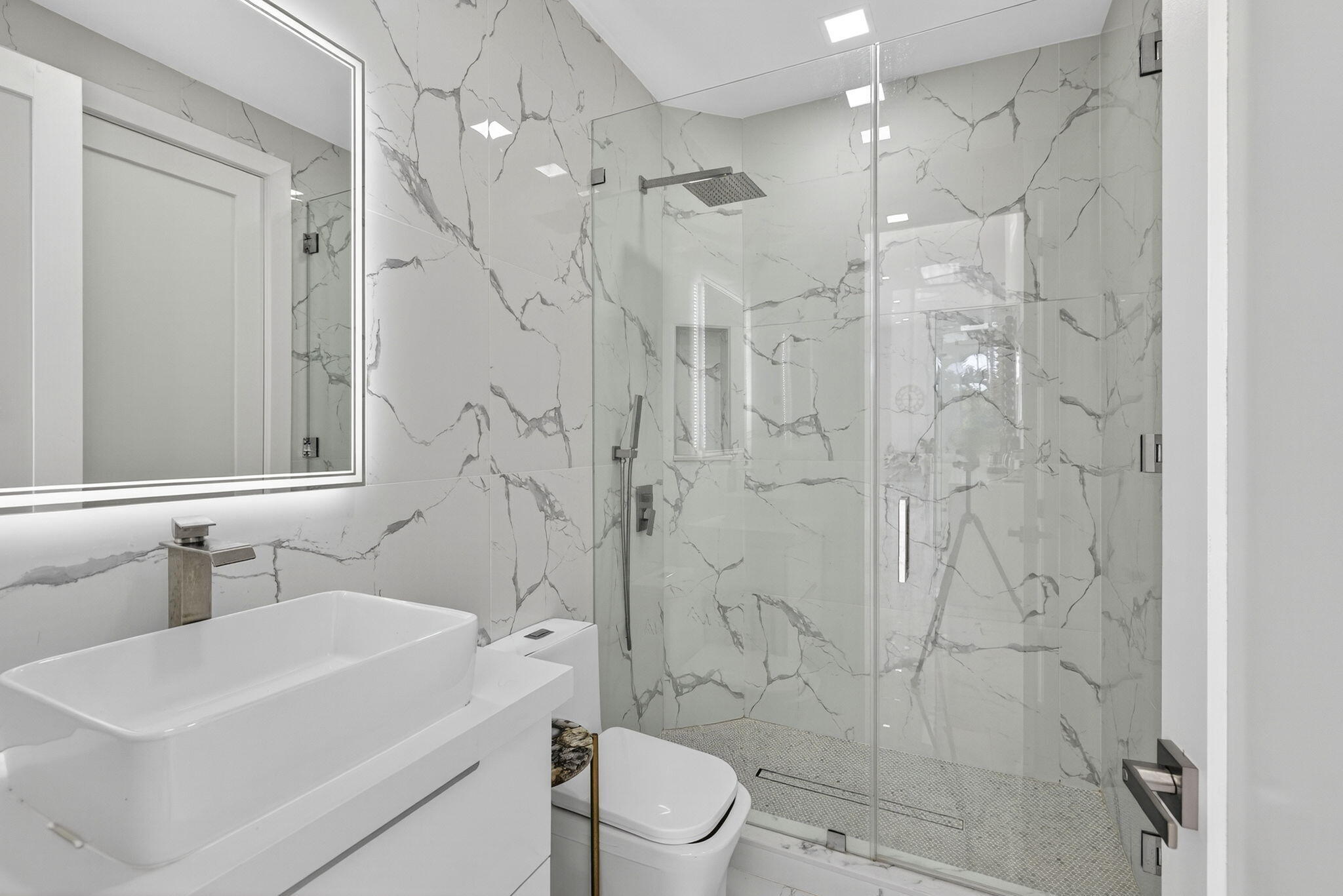 2673 Northwest 64th Boulevard Boca Raton, FL 33496 - Photo 32 of 64 a bathroom with a sink toilet a mirror and shower