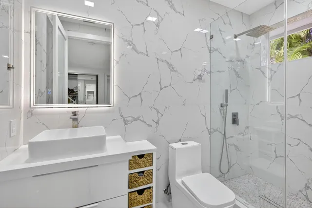 a bathroom with a sink toilet and shower